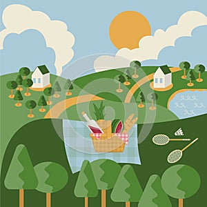 Landscape composition with picnic basket and badminton set