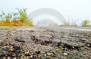 Landscape country field, defect road, close-up bad asphalt,colours stone.