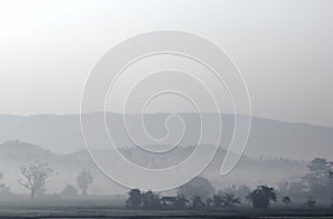 Landscape of countryside in Thailand with mist in the early morn