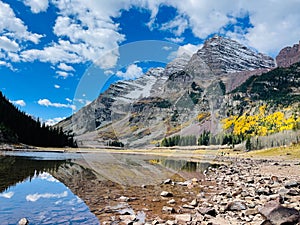 Landscape of Crater Lake Trail at Maroon Bells mountains with blue cloudy sky