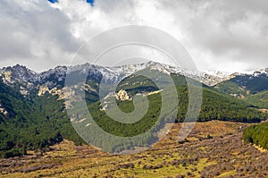 Landscape of Cuerda Larga mountain range with snow in the summits photo