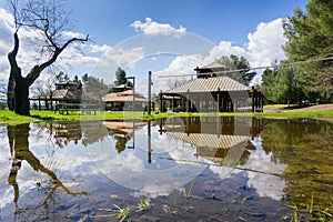 Landscape in Cunningham Lake; covered picnic spots reflected in a pond created by rain, San Jose, south San Francisco bay,