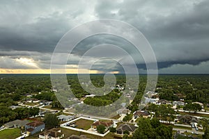 Landscape of dark ominous clouds forming on stormy sky before heavy thunderstorm over rural town area