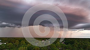 Landscape of dark ominous clouds forming on stormy sky before heavy thunderstorm over rural town area