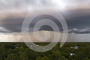 Landscape of dark ominous clouds forming on stormy sky before heavy thunderstorm over rural town area