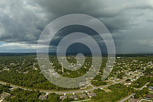 Landscape of dark ominous clouds forming on stormy sky before heavy thunderstorm over rural town area