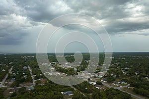 Landscape of dark ominous clouds forming on stormy sky before heavy thunderstorm over rural town area