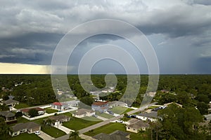 Landscape of dark ominous clouds forming on stormy sky during heavy thunderstorm over rural town area