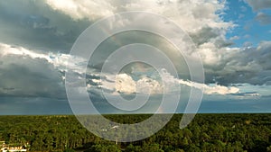 Landscape of dark ominous clouds forming on stormy sky before heavy thunderstorm over rural town area