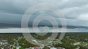 Landscape of dark ominous clouds forming on stormy sky during heavy thunderstorm over rural town area