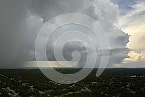 Landscape of dark ominous clouds forming on stormy sky during heavy thunderstorm over rural town area