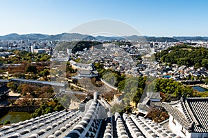 Landscape day view from the top of Himeji Castle overlooking Himeji city and fortifications in autumn, Japan.