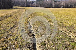 Landscape degradation by field erosion