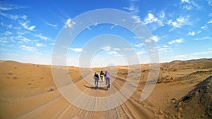 Mountain bikers riding the bike in a desert road