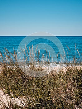 Landscape of deserted beach with tranquil sea and blue sky