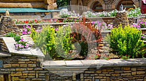 Landscape design of home garden, landscaping with stone retaining walls and flowerbeds