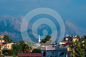 Landscape with distant blue mountains behind city rooftops, Kemer, Antalya, Turkey