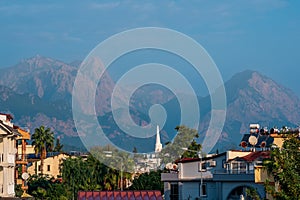 Landscape with distant blue mountains behind city rooftops, Kemer, Antalya, Turkey