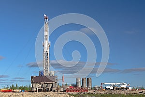 Landscape with a drilling rig in an oil and gas field