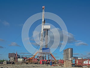 Landscape with a drilling rig in an oil and gas field
