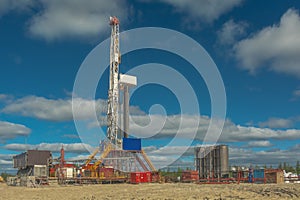 Landscape with a drilling rig in an oil and gas field