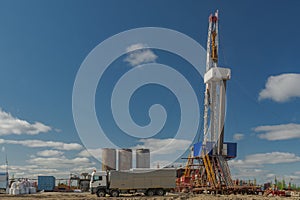 Landscape with a drilling rig in an oil and gas field