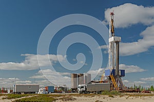 Landscape with a drilling rig in an oil and gas field