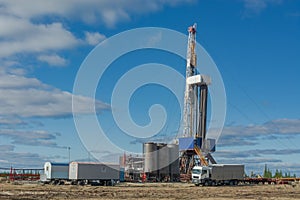 Landscape with a drilling rig in an oil and gas field