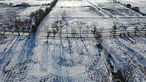 Landscape from a drone, a road covered with snow among fields in Poland. Winter landscape from a drone