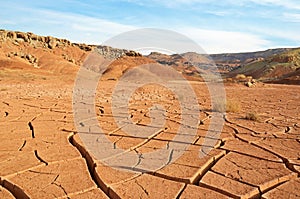 The landscape of dry mountains and mud cracked pattern on desert ground