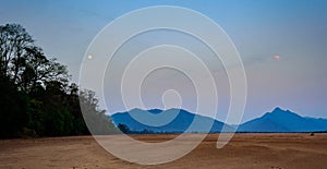 Landscape of Eastern Ghat Mountains and Mahanadi River bed as the moon sets and the dawn arrives, copy space