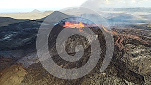 Landscape of erupting Mauna Loa Volcano in Hawaii with smoke and blue horizon sky