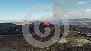 Landscape of erupting Mauna Loa Volcano in Hawaii with smoke and blue sky horizon