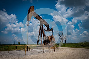 Landscape featuring an oil derricks set against a beautiful blue sky