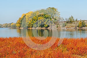 Landscape featuring a river with calm water in autumn photo