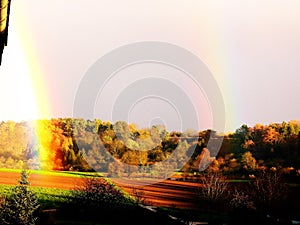 Landscape with fields and autumn forest and great rainbow  2