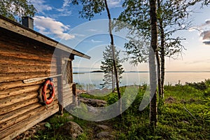 Landscape with finnish sauna building and the gulf of Bothnia on background