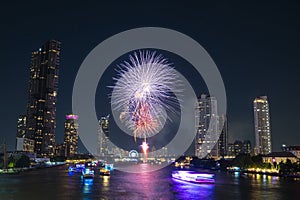 Landscape of firework at Taksin Bridge with chaopraya river. downtown Bangkok City Thailand