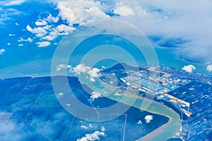 Landscape of fluffy white clouds on a dark blue sky. View from the plane at high altitude