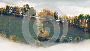 Landscape of foggy valley in an autumn morning