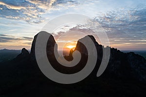 Landscape forest and mountain at sunset with twilight sky aerial view. Aerial View overlooking a green valley with a large