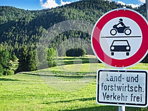 Landscape with forest and pasture and traffic signs