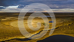 Landscape of the forest-tundra in autumn and the sandy river bank, bird`s eye view.Arctic Circle, tunda. Beautiful landscape of photo