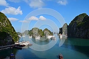 Landscape formed by karst towers-isles on blue sky background. Beautiful view of lagoon in the Halong Bay Descending Dragon Bay