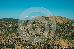 Landscape with fortress of on top of hill and small farms