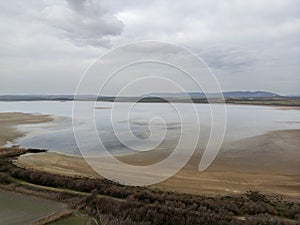 landscape of the Fuente de Piedra lagoon on a rainy, grey day, Andalusia