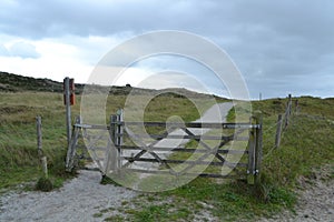 Landscape with gate of a shell footpath in the Dutch dunes