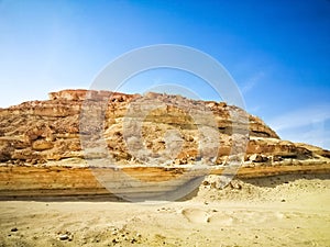 Landscape of Gebel al-Mawta under the sunlight and a blue sky in Egypt