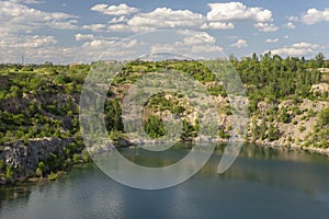 landscape of a granite quarry against a summer cloudy sky