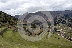 Landscape with green Andean Mountains and Inca ruins on the hiking path in Pisac archeological park, Peru